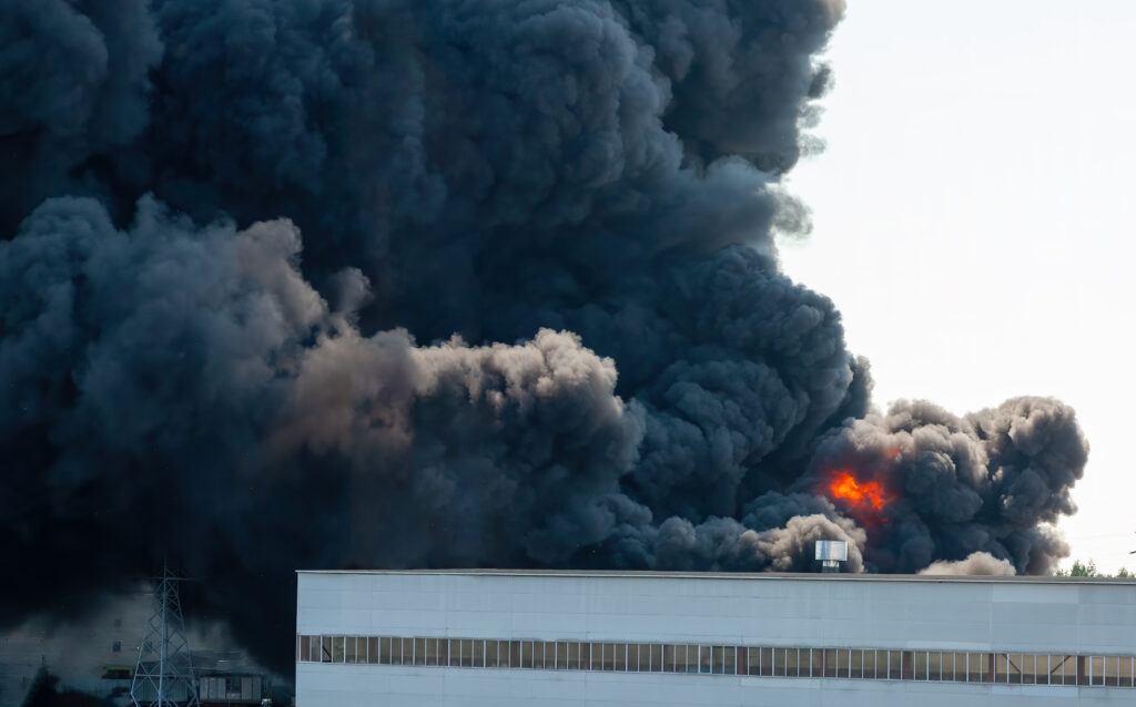 Black plumes of smoke from an accidental industrial fire