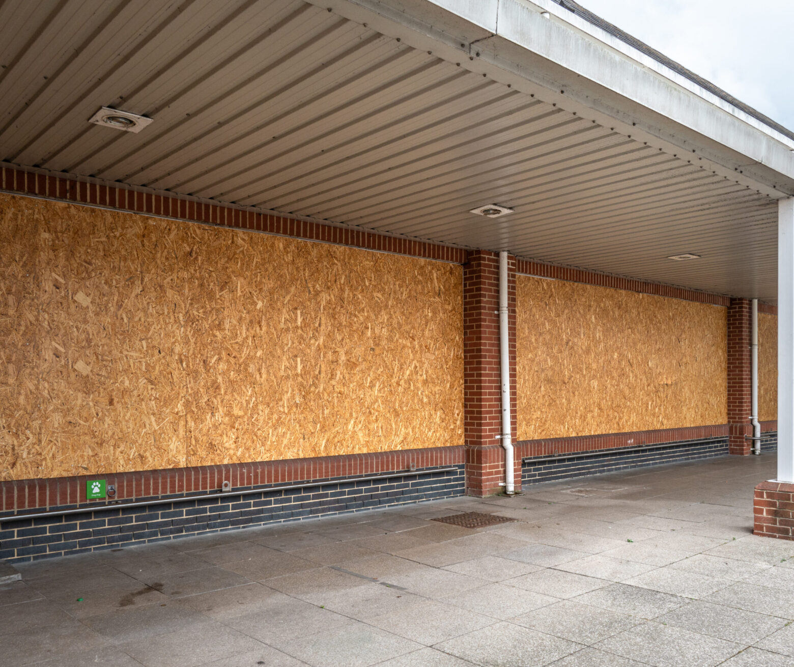 Boarded up windows of a supermarket that has closed down.