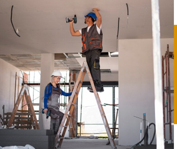 Construction workers installing ceiling wiring.